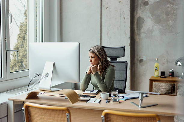 istock Worried businesswoman working on a computer in the office. 2235860875