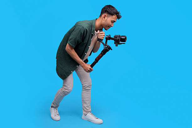 Young Male Operates A Professional Camera On A Gimbal Stabilizer