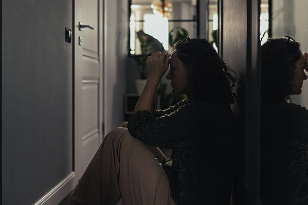 istock A person seated on the floor, silhouetted against soft interior light, evokes reflection and introspection. The dramatic lighting emphasizes the contemplative mood. The scene captures a sense of solitude and thoughtfulness. 2235861595