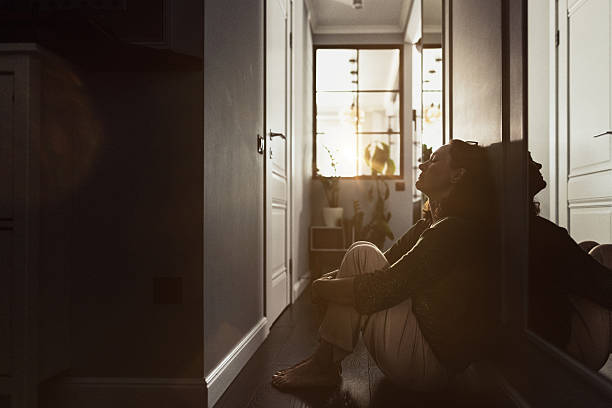 istock A person seated on the floor, silhouetted against soft interior light, evokes reflection and introspection. The dramatic lighting emphasizes the contemplative mood. The scene captures a sense of solitude and thoughtfulness. 2235861649