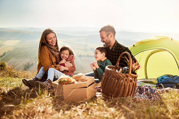 istock Cheerful family having fun during camping day in nature. 2235861742