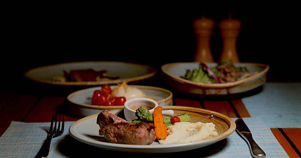 istock Sizzling steak with mashed potatoes, vegetables, and sauce on elegant 2235862783