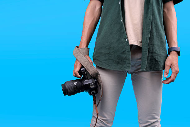 istock Closeup View of Man Holds Camera With A Large Lens 2235862915