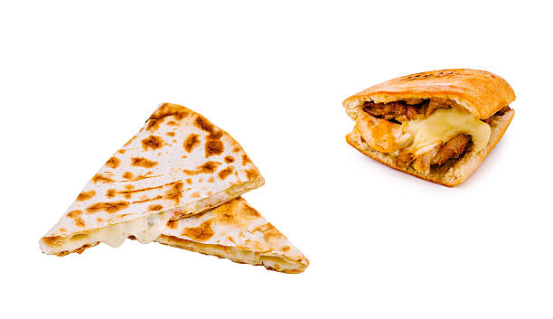 Two mouthwatering dishes are laid out side by side, featuring a warm, sizzling flatbread filled with creamy cheese and a flaky pastry stuffed with tender, seasoned chicken.