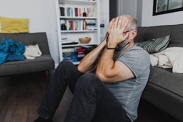 Thoughtful Elderly Man Sitting at Home in Deep Contemplation. Life Problems Concept