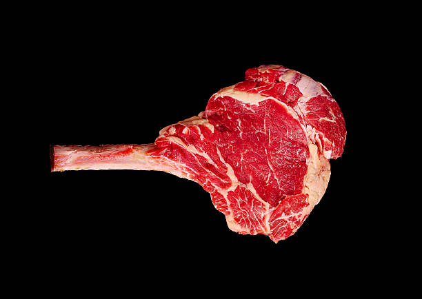 istock Tomahawk steak on a black background ready for grilling or cooking 2235863607
