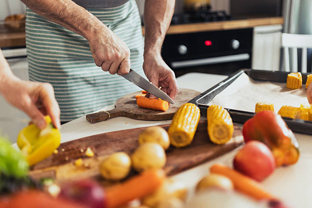 istock Hands Preparing Vegetables on a Cutting Board for a Healthy Meal 2235863706