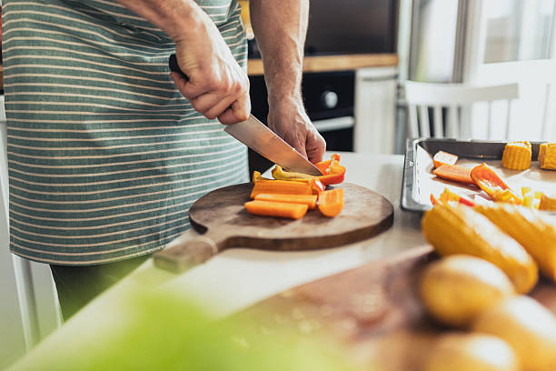 istock Hands Preparing Vegetables on a Cutting Board for a Healthy Meal 2235863771