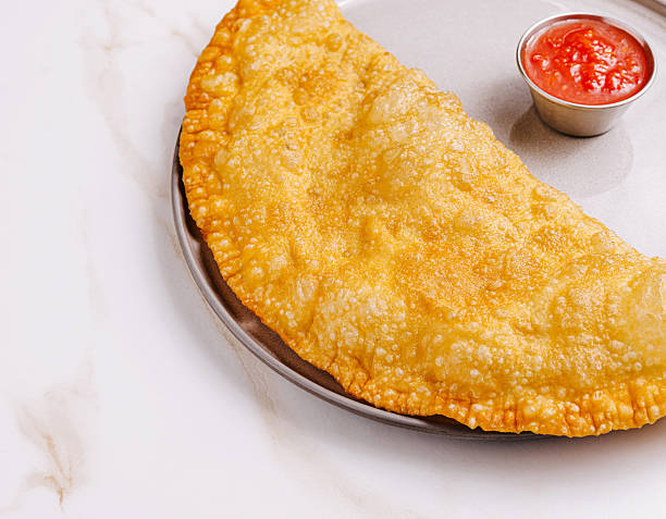 istock Crispy fried pastry accompanied by spicy dipping sauce on a plate 2235863917