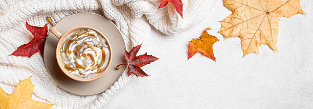 istock Autumn latte coffee with maple leaves and cozy plaid 2235863965
