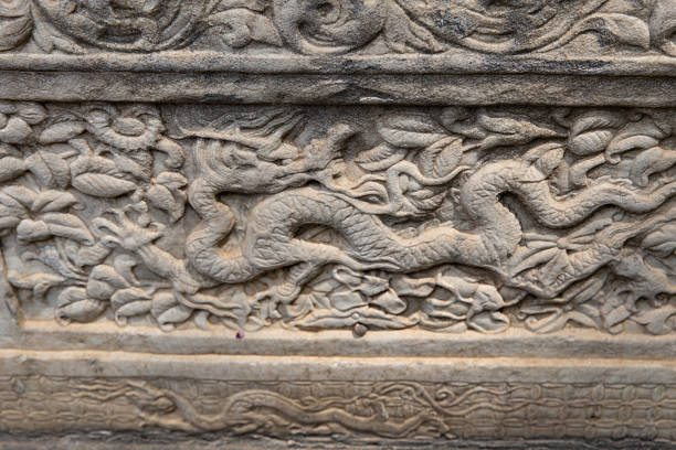 This image features an elaborate stone carving with traditional cloud patterns and decorative borders, showcasing exquisite craftsmanship.