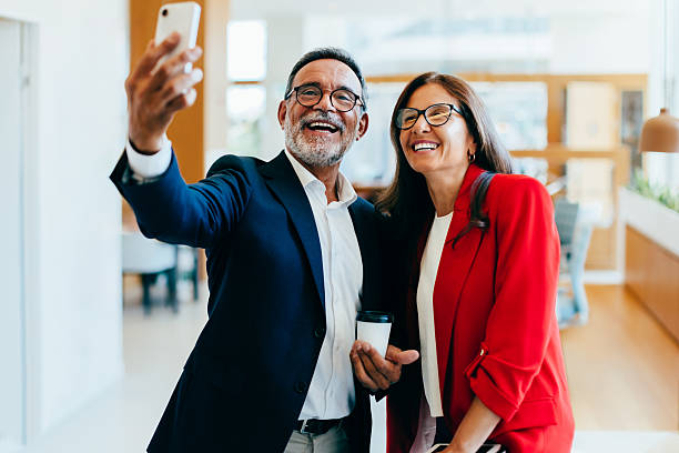 istock Two senior managers smiling while taking a smartphone selfie together 2235868933