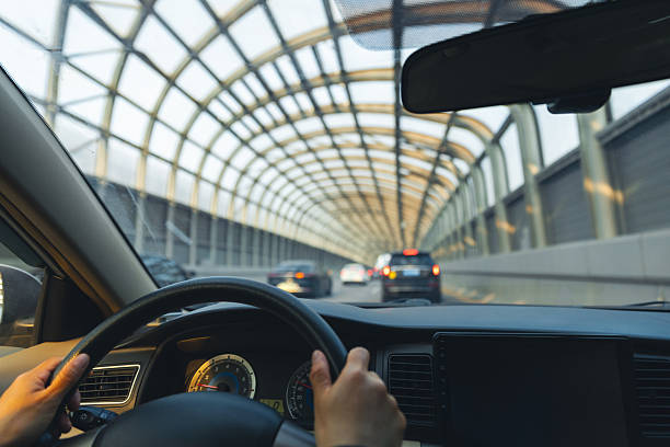 istock People driving car in tunnel 2235869205