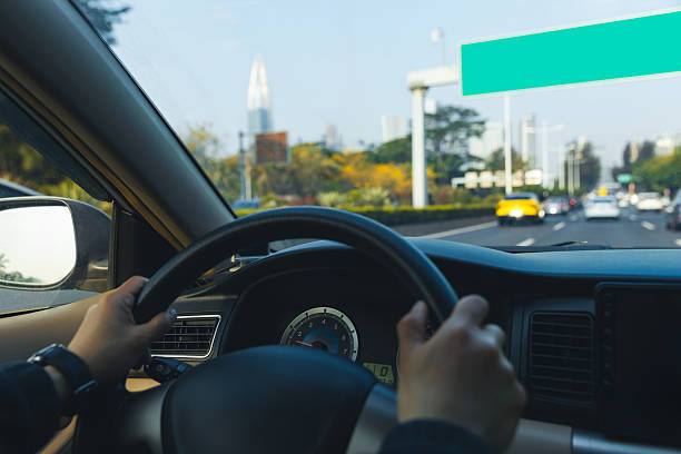 istock People driving car in city 2235869626