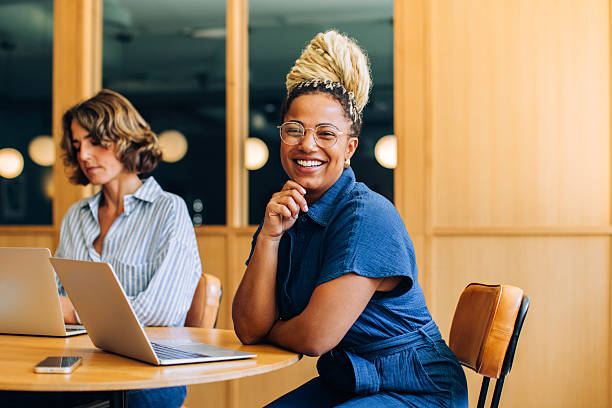 istock Professional women working and smiling in a modern office setting 2235871234