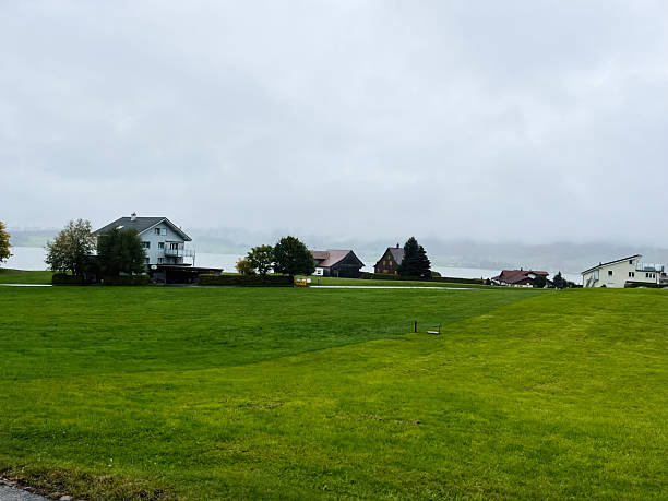 istock Rustic Swiss countryside with homes and green fields on an overcast day 2235871535