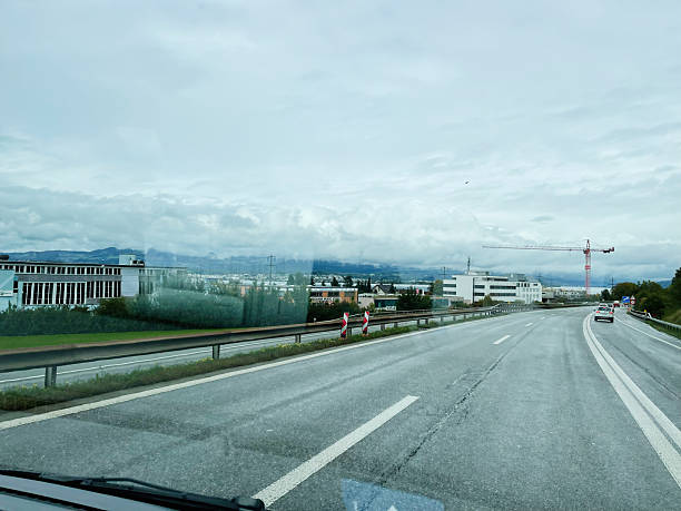istock Highway view with construction crane and buildings under a cloudy sky in Switzerland 2235871569