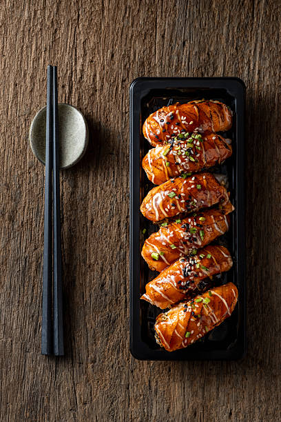 Delicious sushi presentation with salmon and rich sauces on plate