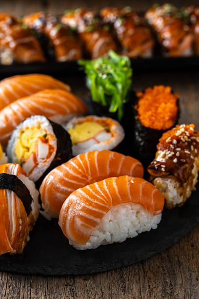 istock Fresh Salmon Sushi Rolls Served on a Black Slate Plate 2235871931