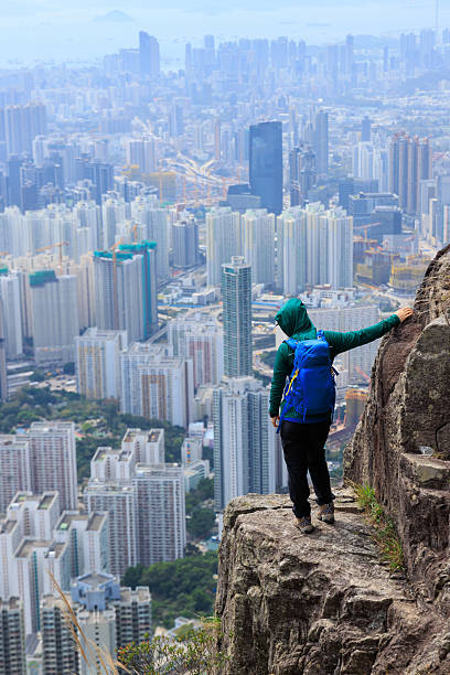 istock Successful backpacker enjoy the view stand on the cliff edge in hong kong 2235872681