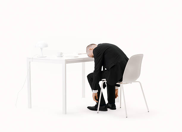 istock Exhausted businessman sleeping at his desk 2235876837