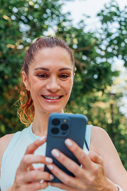 istock Fitness enthusiast checking smartphone app after outdoor workout, tracking progress and staying motivated in park environment 2235877489