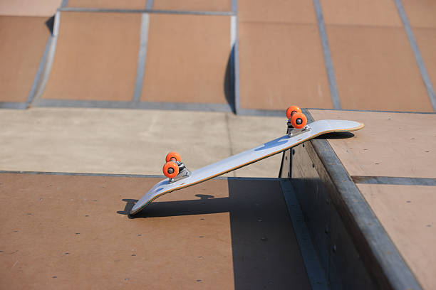 Skate boarding boy and jump trick on skate board outdoors park.