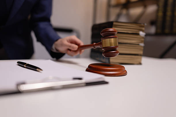 istock Lawyer holding a court hammer. 2235878175