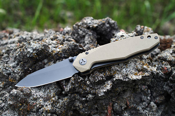 istock Folding tourist, camping knife with black blade and handle made 2235878543