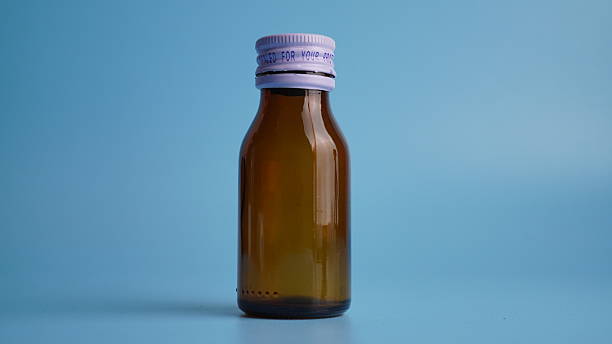 istock Dark empty medicine bottle on blue background 2235878765