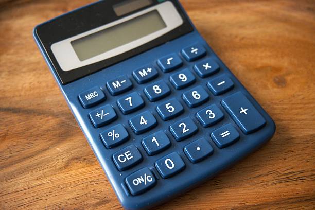 istock Blue calculator on wooden desk close-up 2235879362