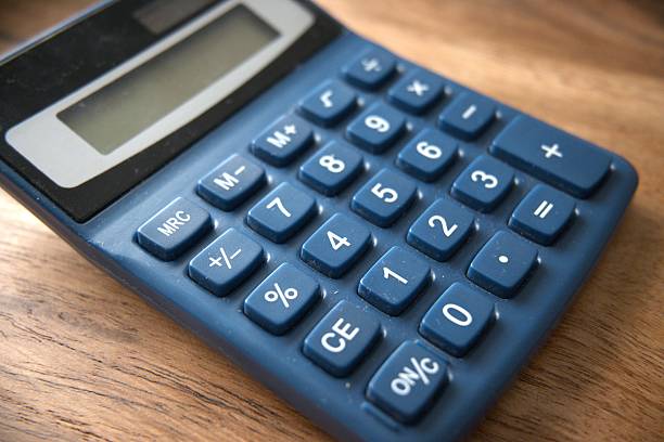 istock Blue calculator on wooden desk close-up 2235879363