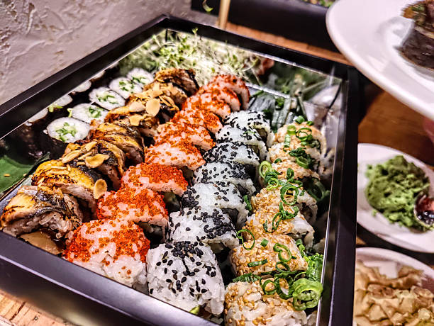 Tasty sushi rolls in set at the table with ginger and wasabi