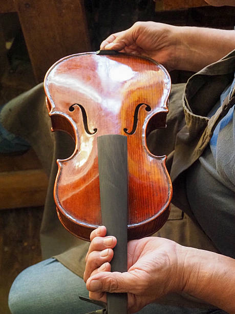 Cremona, Italy - September 3rd 2025 Artisan Cremona Italy Crafting a Violin in Summer Sunlight Town Center Detailed Workmanship and Cultural Heritage
