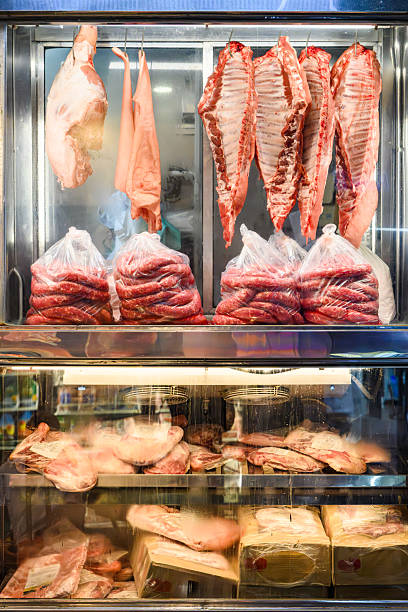 istock Display of assorted fresh meats in a butcher shop's refrigerated case 2235880517