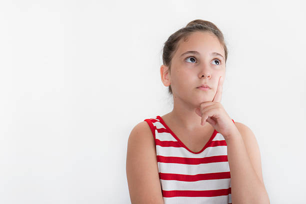 Cute little girl thinking and looking up on white background