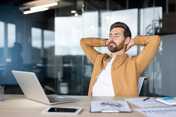 istock Businessman taking a break at his desk in a modern office environment. 2235882672