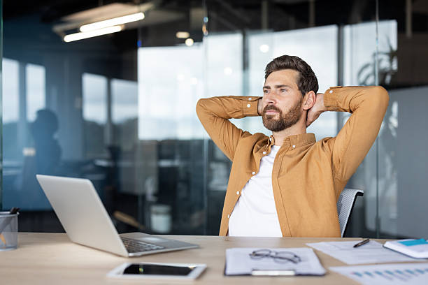 istock Confident man relaxing at desk in modern office environment 2235882674