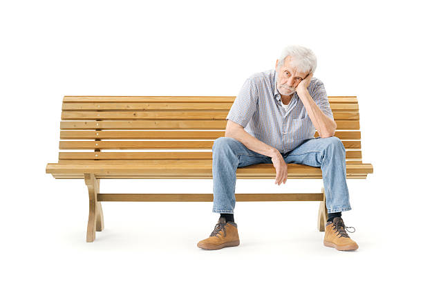Man with depression and headache sitting on a chair at home.