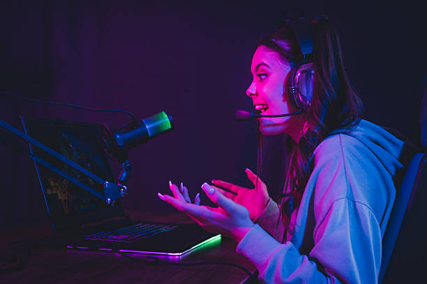 istock Addicted gamer streamer broadcasting online with vibrant neon lighting and headset during evening gaming session 2235884079