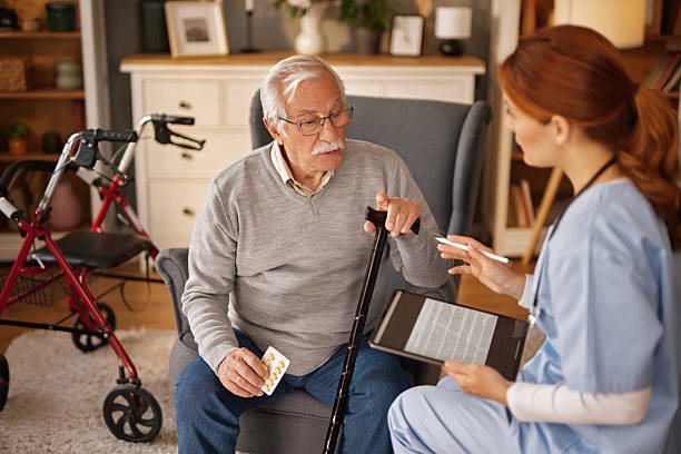 istock Nurse explaining medication instructions to senior man at home 2235884369