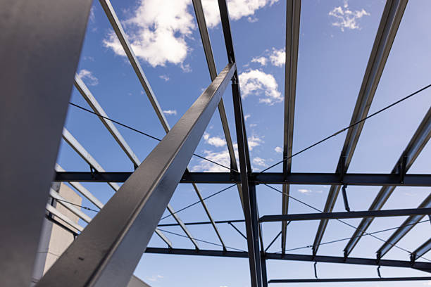istock Steel frame structure rising against blue sky with clouds 2235885789