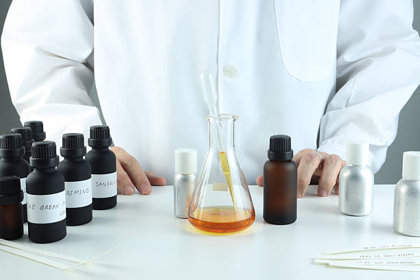 istock chemical beaker , flask is on white table with blotting paper for testing blending perfume , candle and room freshener in the lab of home fragrance factory 2235888687
