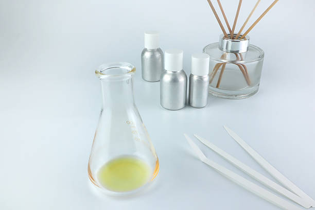 istock chemical beaker , flask is on white table with blotting paper for testing blending perfume , candle and room freshener in the lab of home fragrance factory 2235888693