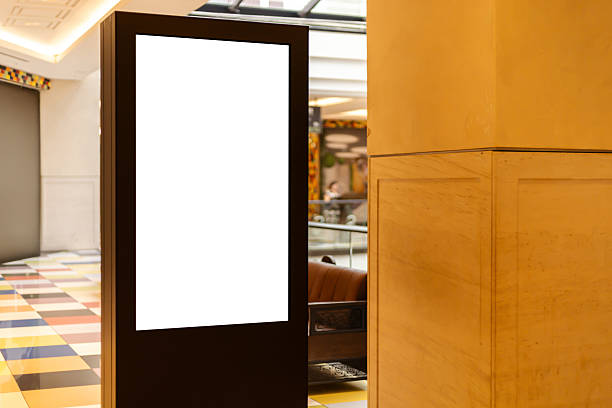istock A digital display stand is positioned in a modern lobby area. The sleek design features a blank screen, offering space for advertisements 2235888830