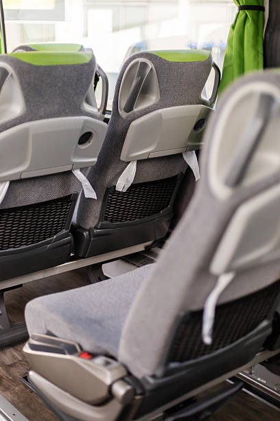 istock Bus interior featuring comfortable, modern seats with a sleek design. The arrangement promotes passenger comfort while enjoying the journey. Green accents add a fresh touch 2235889350