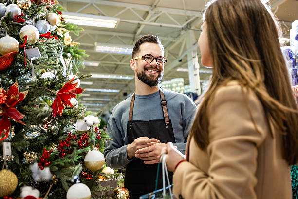 istock Smiling sales assistant helping customer shop in boutique 2235890621