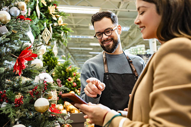 istock Customer service scene with young woman and store assistant 2235890716