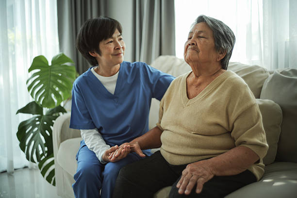 istock Elderly woman doing breathing exercises at home. 2235895394
