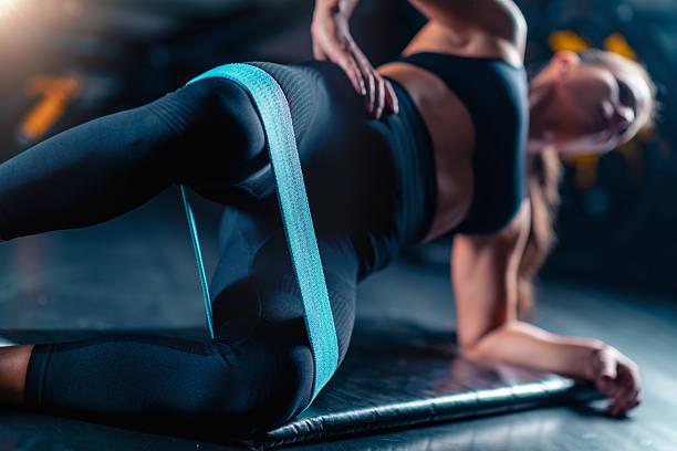 istock Using an elastic band for strength training in the gym, a woman improves power and flexibility. This effective workout supports health goals and enhances vitality with dynamic resistance. 2235895461